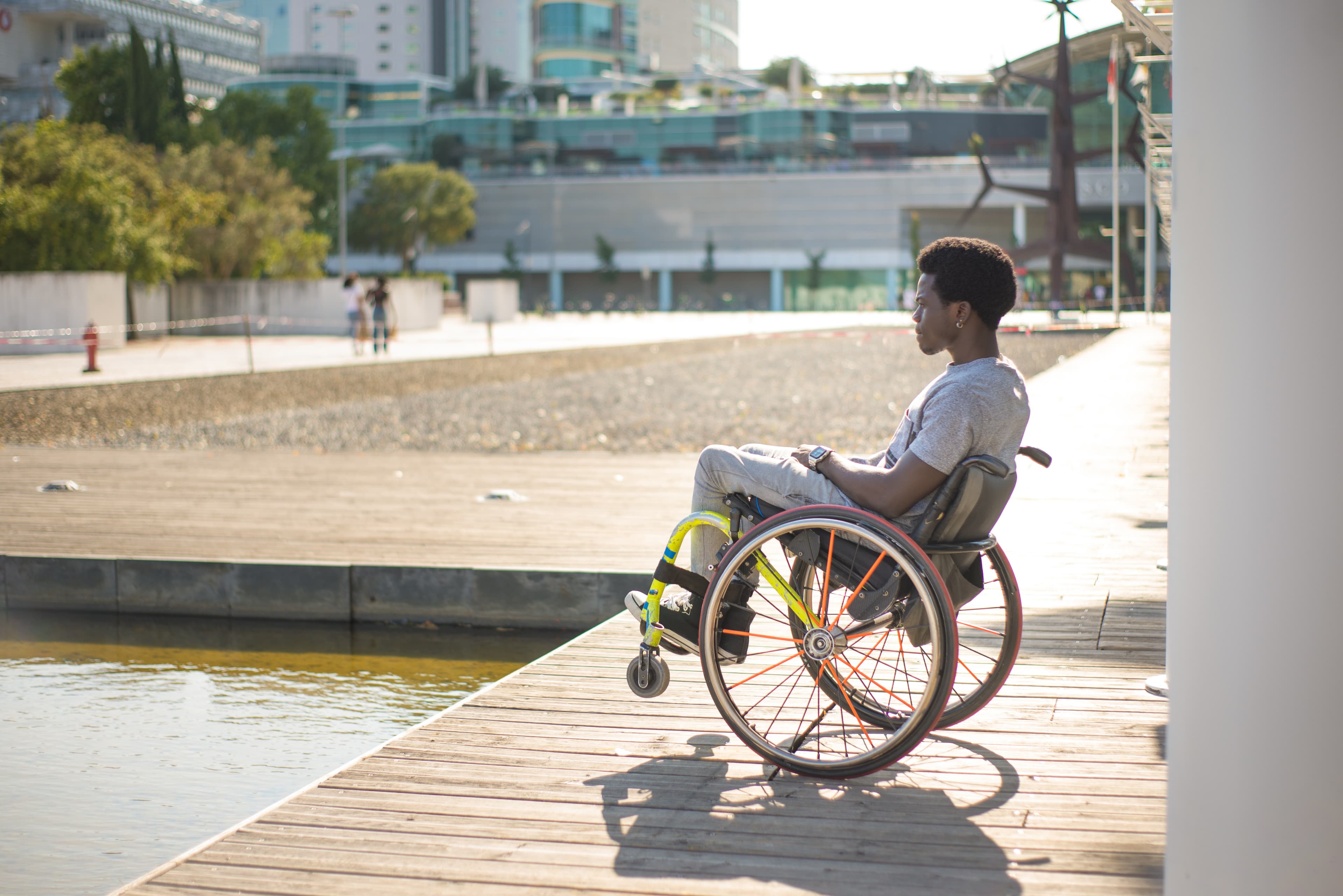 Young woman in wheelchair by the water